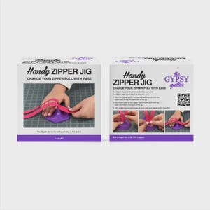 May include: Two white boxes with the text "Handy ZIPPER JIG" and instructions for use. The boxes show a purple jig with pink ribbon. The text on the box says the jig works with pull sizes 3, 4.5, and 5.