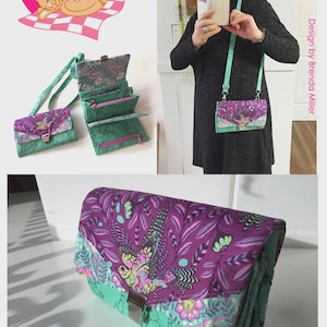 May include: A multi-featured Chatelaine wallet with a purple and teal floral design. The wallet has a flap closure and a teal strap. The image also shows a matching small purse and a logo that says "Among Brenda's Quilts & Bags."