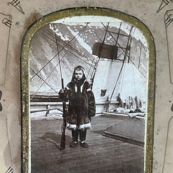 Theodore C. Marceau 1880  Enamled photo ship Boy w/ Winchester Rifle  Inuit qulittaq, kamiit in a Victorian acorn & leaves oak frame
