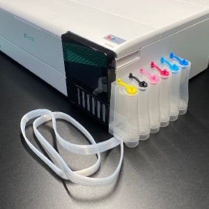 May include: A white printer with a black control panel and a clear tube. The printer has five ink cartridges, one yellow, one magenta, one cyan, one black, and one blue.