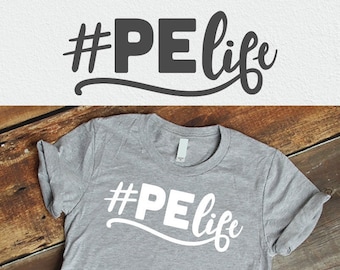 May include: A gray t-shirt with the text "#PElife" in white letters. The shirt is on a wooden surface.