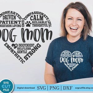 May include: A white t-shirt with a black heart design. The heart is filled with text that describes the qualities of a dog mom. The text includes words like "kindhearted", "driven", "patient", "understanding", "loving", "compassionate", "calm", "reliable", "thoughtful", "loyal", "independent", "selfless", "gentle", "empathetic", and "strong".