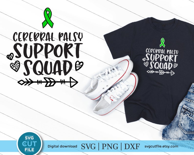 May include: A black t-shirt with a green ribbon and the text "Cerebral Palsy Support Squad" in white. The text is surrounded by small white hearts and arrows. The t-shirt is on a white wooden surface with a pair of white sneakers.