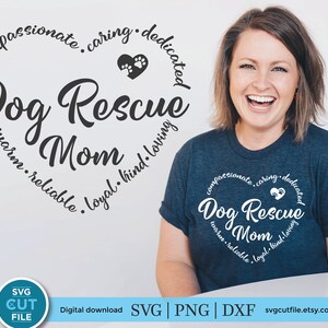 May include: A blue t-shirt with a white heart design that says "Dog Rescue Mom" with the words "compassionate, caring, dedicated, warm, reliable, loyal, kind, loving" around the heart.