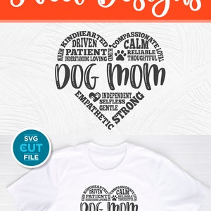 May include: A white t-shirt with a black heart-shaped design that says "Dog Mom" surrounded by words describing a dog mom's personality traits. The words include "Warm", "Kindhearted", "Compassionate", "Calm", "Driven", "Patient", "Reliable", "Understanding", "Loving", "Thoughtful", "Independent", "Selfless", "Gentle", "Empathetic", and "Strong".