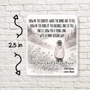 May include: A white rectangular sticker, 2.5 inches in height, with a black and white illustration of a person standing in a field. The sticker has text from a Phil Ochs song, including the lyrics "Show me the country..." and "And there but for fortune..."