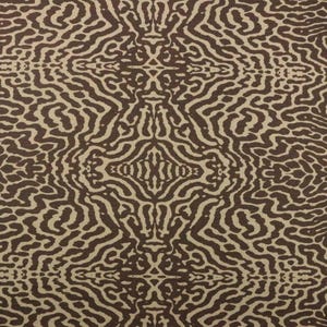 May include: A brown and beige fabric with a repeating pattern of wavy lines. The pattern is symmetrical and creates a sense of movement.