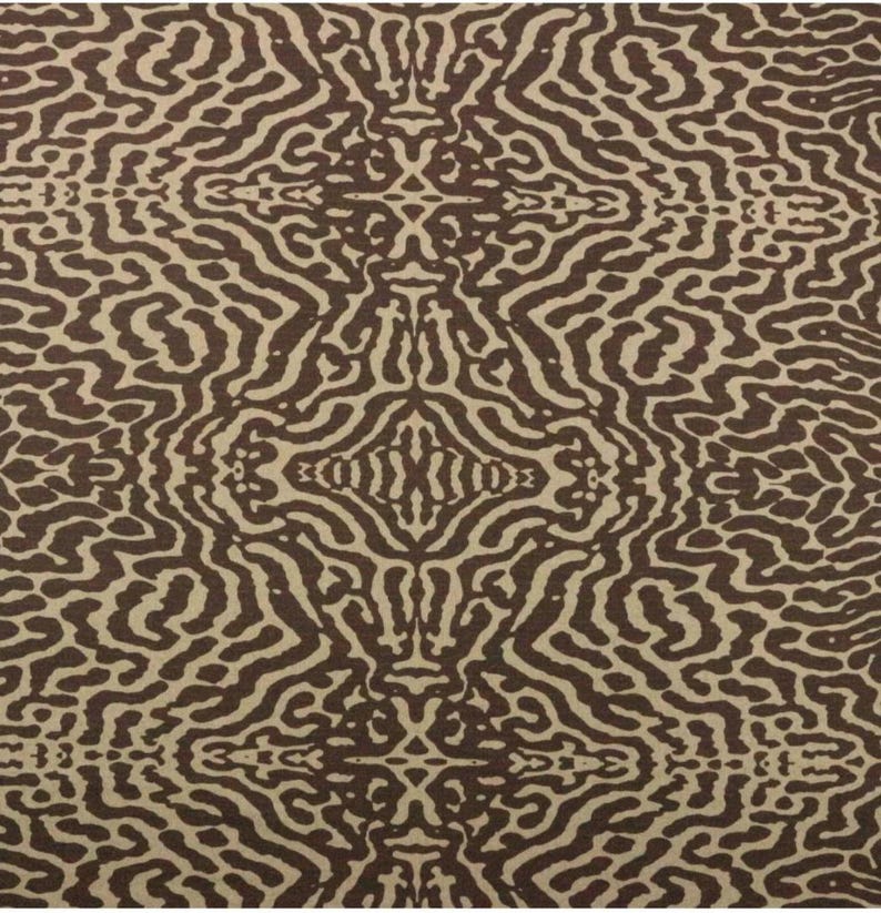 May include: A brown and beige fabric with a repeating pattern of wavy lines. The pattern is symmetrical and creates a sense of movement.