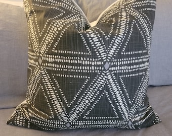May include: A black and white geometric patterned throw pillow with a white border.