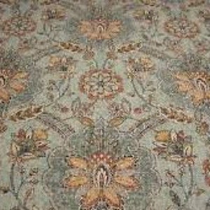 May include: A teal fabric with a floral pattern in shades of orange, brown, and red. The fabric features a repeating design of stylised flowers and leaves.