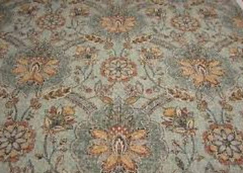 May include: A teal fabric with a floral pattern in shades of orange, brown, and red. The fabric features a repeating design of stylised flowers and leaves.