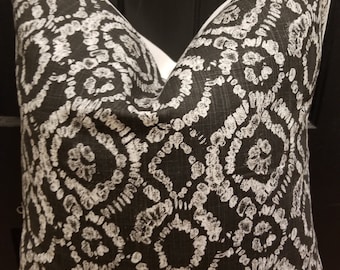 May include: Black and white patterned cushion with a geometric design. The cushion is made of a soft, textured fabric.