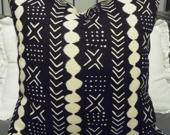 May include: Black and white throw pillow with a geometric pattern. The pattern features white chevron shapes, dots, and crosses on a black background.