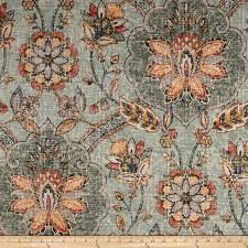 May include: A teal blue fabric with a floral pattern in shades of orange, yellow, brown, and red. The fabric has a textured, linen-like appearance.