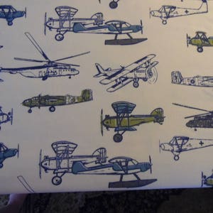 May include: A white background with a repeating pattern of blue airplanes. The airplanes are in various sizes and positions, some are flying, some are landing, and some are taking off.