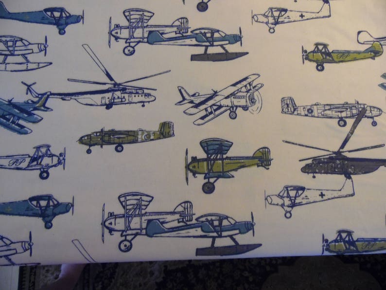 May include: A white background with a repeating pattern of blue airplanes. The airplanes are in various sizes and positions, some are flying, some are landing, and some are taking off.