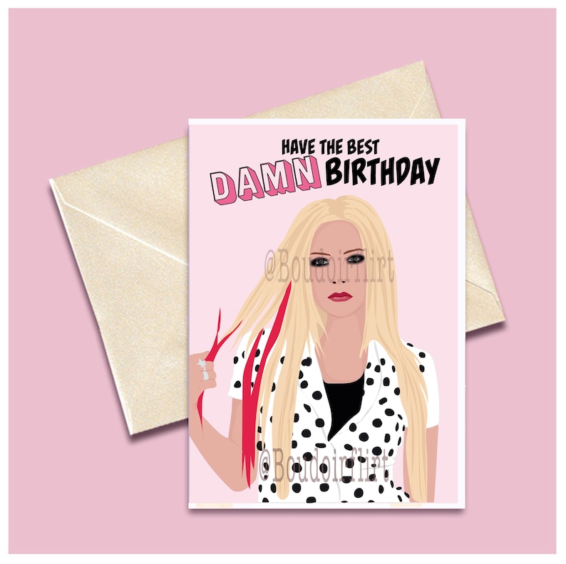 May include: A pink birthday card with a cartoon illustration of a woman with blonde hair and a black and white polka dot shirt. The text on the card reads "Have the best DAMN BIRTHDAY".