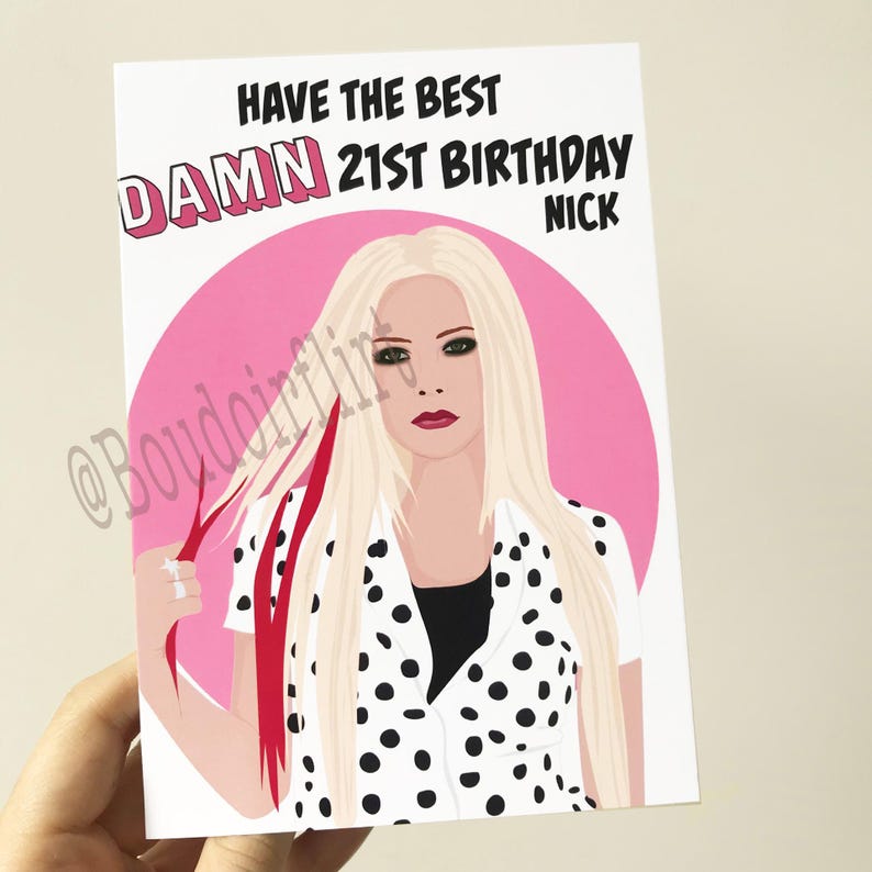 May include: A birthday card with a pink background and a cartoon illustration of a woman with blonde hair and black and white polka dot clothing. The text on the card reads "Have the best DAMN 21st Birthday NICK".