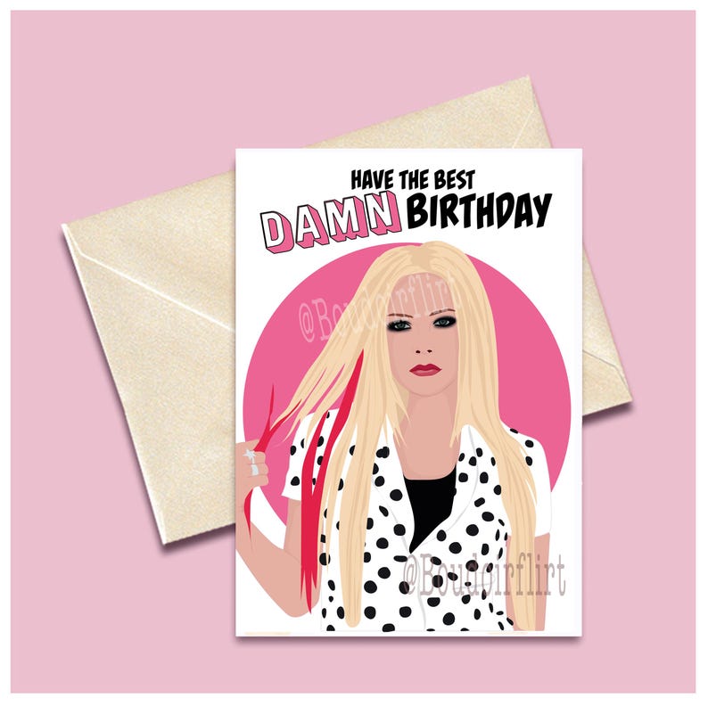 May include: A birthday card featuring a cartoon illustration of Avril Lavigne with pink and black polka dot clothing and pink streaks in her blonde hair. The text on the card reads "Have the best DAMN BIRTHDAY".