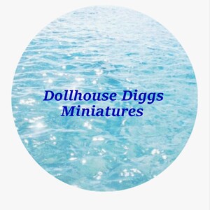 May include: A blue and white image of a sparkling ocean with the text "Dollhouse Diggs Miniatures" in blue.