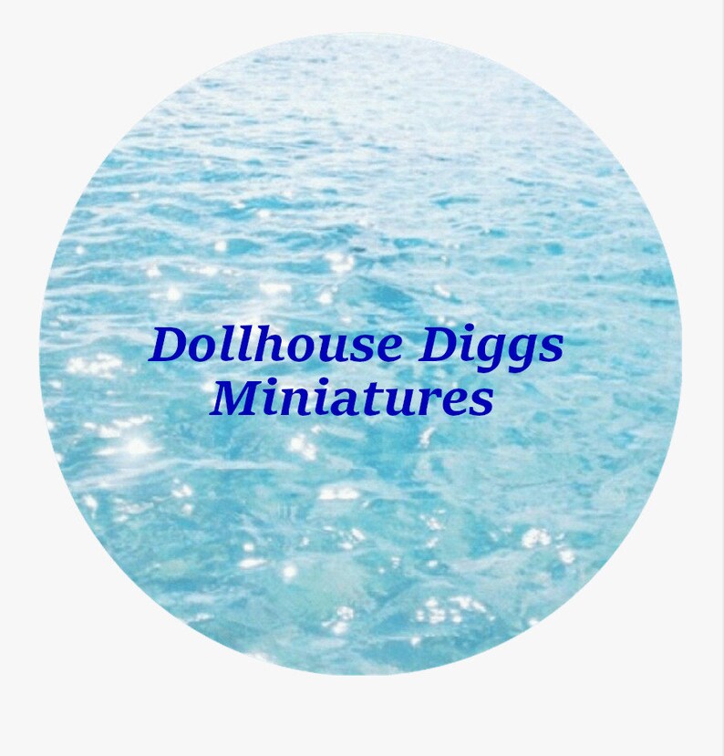 May include: A blue and white image of a sparkling ocean with the text "Dollhouse Diggs Miniatures" in blue.