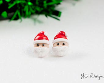 May include: A pair of red and white Santa Claus earrings. The earrings are made of polymer clay and are about 1 inch tall.
