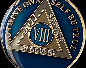 May include: Gold and blue sobriety coin with the words "To thine own self be true" around the edge and a triangle with the words "Unity, Service, Recovery" and the Roman numeral "VIII" in the centre.