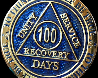 May include: Gold-colored coin with a blue triangle design. The triangle has the words "Unity", "Service", and "Recovery" inscribed on each point. The center of the triangle has a circle with the number "100" and the words "Days" inscribed. The coin has the text "To Thine Own Self Be True" inscribed around the edge.