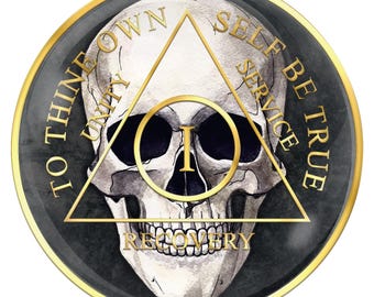 May include: A black and gold round medallion with a skull and crossbones in the center. The skull is inside a triangle with the words "To Thine Own Self Be True" around the outside. The words "Unity", "Recovery", and "Service" are inscribed inside the triangle.