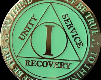 May include: A green and gold sobriety token with the words "To thine own self be true" and "Unity, Service, Recovery" around the edge. The center of the token has a large Roman numeral "I" inside a circle.