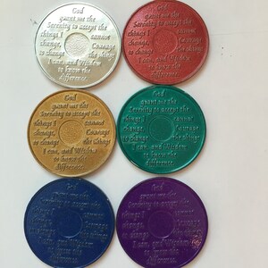 May include: Six round metal tokens with a Serenity Prayer inscription. The tokens are in different colors: silver, red, gold, green, blue, and purple.
