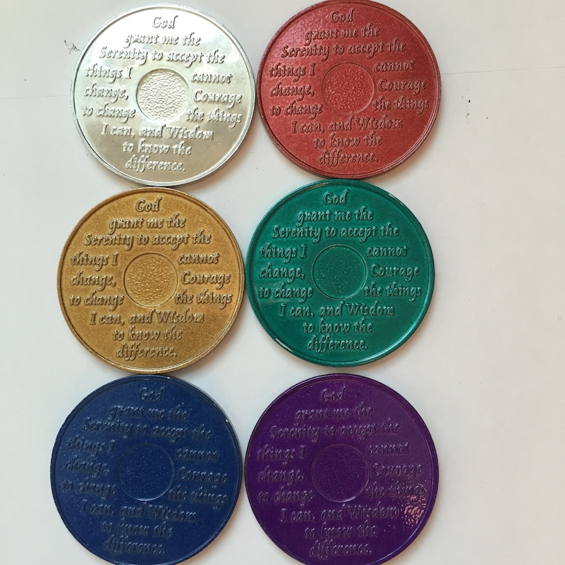 May include: Six round metal tokens with a Serenity Prayer inscription. The tokens are in different colors: silver, red, gold, green, blue, and purple.