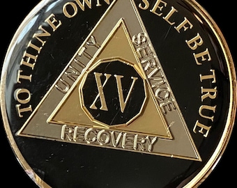 May include: Black and gold 15-year sobriety coin with the words "To thine own self be true" around the edge and a triangle with the words "Unity, Service, Recovery" and the number "XV" in the center.