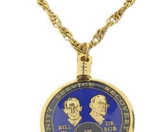 May include: Gold chain necklace with a round pendant. The pendant has a blue background with gold lettering that reads "Unity Service Recovery" and "Bill W. Dr. Bob". The center of the pendant has a black background with a Roman numeral IX and the word "Years".