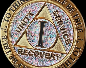 May include: Gold-colored coin with a glittery surface. The coin features a triangle with the words "Unity", "Service", and "Recovery" inscribed around it. The center of the triangle contains the Roman numeral "I". The coin's edge is inscribed with the text "To thine own self be true to thine own self be true".