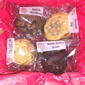 May include: Four different types of cookies in individual clear plastic bags. The cookies are: Quadruple Chocolate Chip, Chocolate Chip, PB Choc Chip, and Nutella Stuffed Bombs.