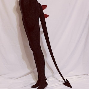 Solid black long spaded tail with two red spikes.