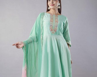 May include: A mint green long-sleeved dress with a floral embroidered neckline and a matching mint green and pink dupatta. The dress has a flared skirt and is paired with white trousers.
