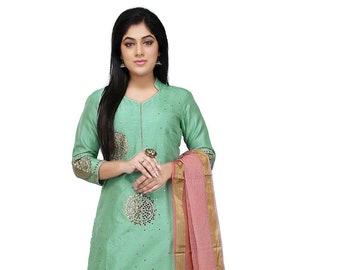 May include: A green salwar kameez with gold and silver embroidery. The outfit includes a long, straight-fitting top, matching trousers, and a sheer dupatta with gold trim.