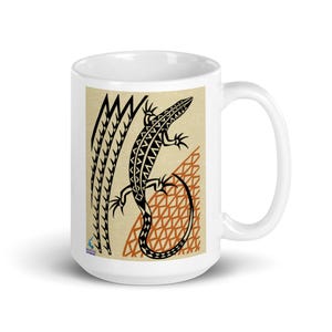May include: White ceramic mug featuring a stylized black and brown lizard design. The lizard is set against a beige background with geometric shapes. The mug has a curved handle and a glossy finish.