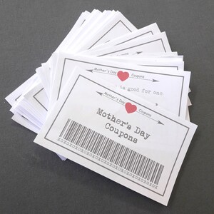 May include: A stack of white cards with a red heart and the text "Mother's Day Coupons" printed on them. The text "is good for one" is also printed on the cards.