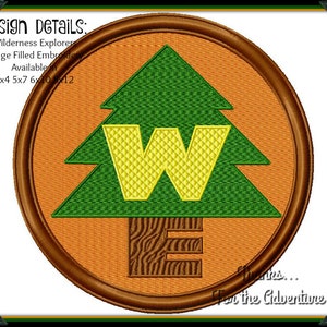 May include: Embroidered patch with a green pine tree, a yellow "W" and a brown "E" on an orange background. The text "Wilderness Explorers... For the Adventure" is at the bottom of the patch.