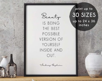 Pode incluir: Um pôster de citação imprimível em preto e branco com o texto "Beleza é ser a melhor versão possível de si mesmo, por dentro e por fora." A citação é atribuída a Audrey Hepburn. O pôster é emoldurado em uma moldura preta e é exibido em uma prateleira de madeira com vasos decorativos.