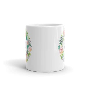 May include: White ceramic mug with a floral design featuring pink and peach flowers and green leaves. The text "Just Breathe" is printed on the mug.