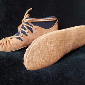 Pode incluir: Um par de sapatos de couro marrom com forro de tecido preto e cadar&ccedil;os. Os sapatos t&ecirc;m uma ponta arredondada e uma sola plana. A sola &eacute; mostrada separadamente.