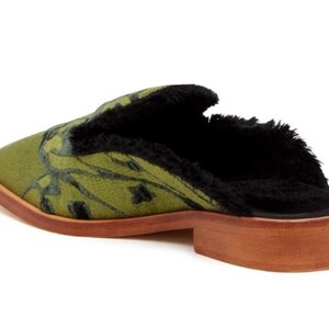 May include: Green and black patterned mule with a faux fur lining and a wooden heel.