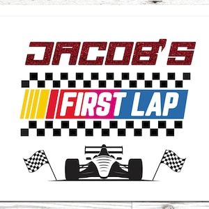 May include: White card with the text "JACOB'S FIRST LAP" in red glitter and colorful block letters. A race car silhouette is at the bottom, with checkered flags on either side. A fun design for a racing-themed event.