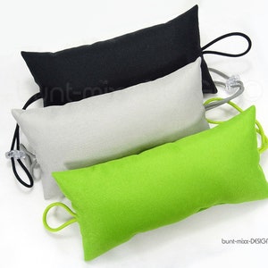 May include: Three fabric doorstops in black, gray, and green. Each doorstop has a drawstring closure and a loop for hanging.