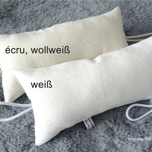 May include: Two white fabric pouches with drawstrings. The top pouch is labelled "écru, wollweiß" and the bottom pouch is labelled "weiß".