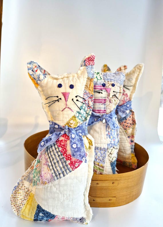 Quilted cat with rustic collar and embroidered face